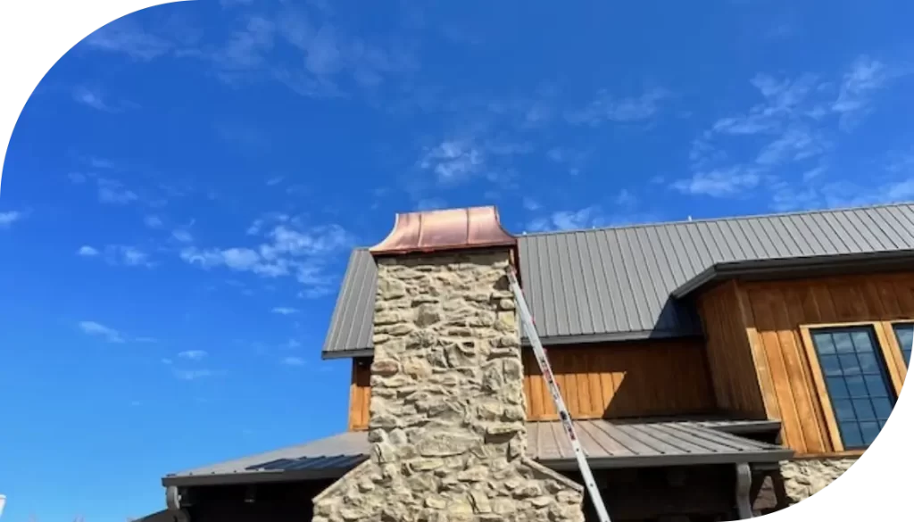 Copper outdoor fireplace top by ABC Roofing.