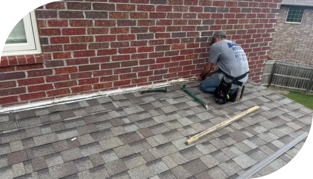 A man fixing a shingle roof.